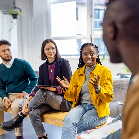 Four individuals engaged in a career-focused discussion, supporting content on job search, promotion, and skill development.